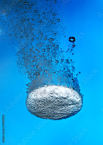 Effervescent tablet in water with bubbles