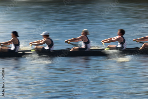 Teamwork, rowers in a rowing boat pulling in harmony