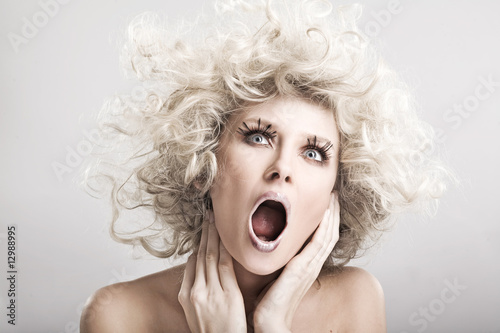 Beautiful blond woman screaming, artistic makeup