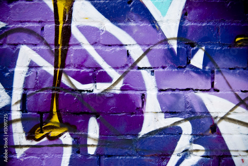 Graffiti detail on a textured brick wall