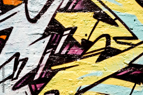 Abstract graffiti closeup on the textured brick wall