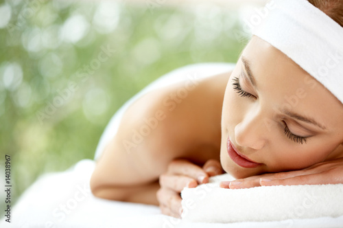 Young beautiful and relaxed lady taking spa treatment