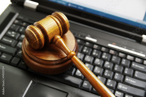 judges gavel on a laptop computer (cyber law)