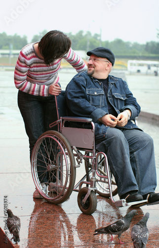 Man in a wheelchair talking with woman