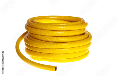 The yellow rubber garden hose on a white background (isolated).