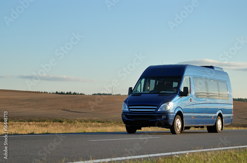 Blue minibus on highway