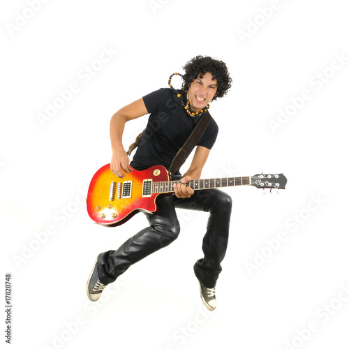 Young guitarist jumping isolated