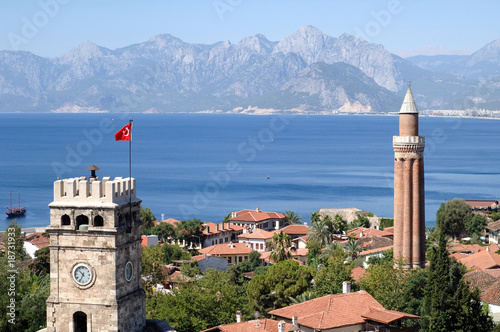 close up shot of a clock tower and minaret in Antalya