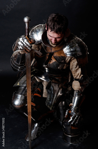 Great knight holding his sword and helmet