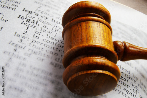 closeup of a gavel and dictionary legal definition