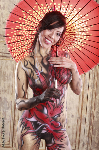 Dragon bodypainting asian girl with umbrella