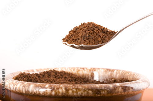 Coffee grounds on a spoon.