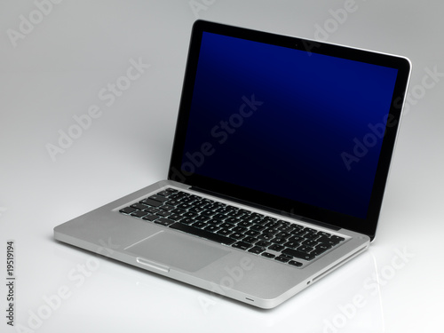 Laptop on gray fond