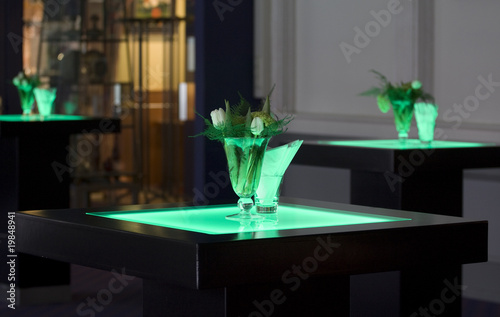 Hotel ballroom with luminous bar tables