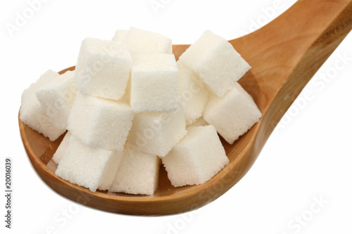 Sugar in a wooden spoon on a white background