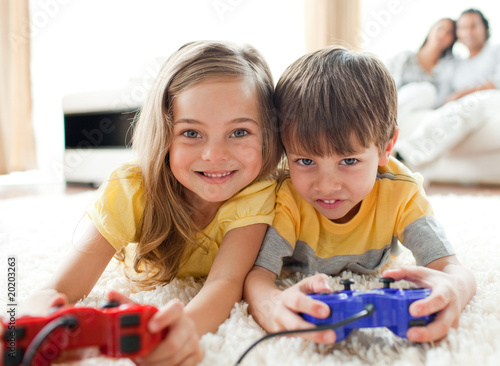 Adorable siblings playing video game
