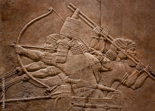 Ancient relief of assyrian warriors fighting in the war
