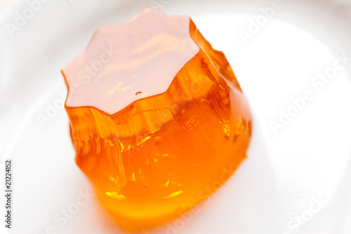 orange jello on white plate, close-up