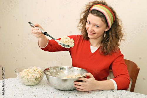 young woman eating salad