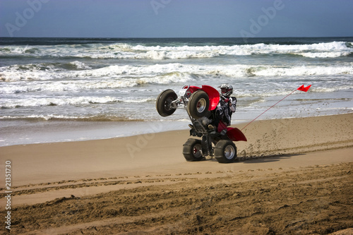 ATV rider wheelie on beach