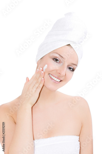 Towel on head blonde caucasian woman creaming face