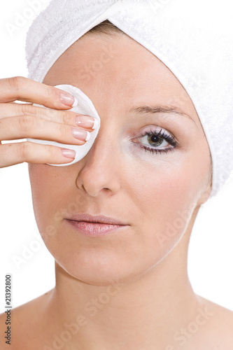 caucasian woman cleaning face after makeup