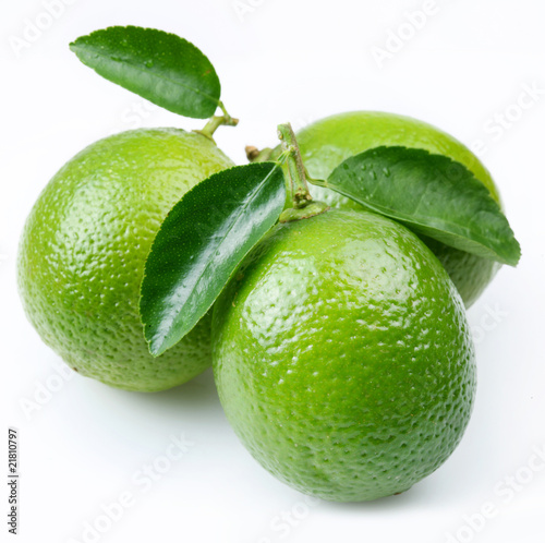 Lime with leaves on a white background