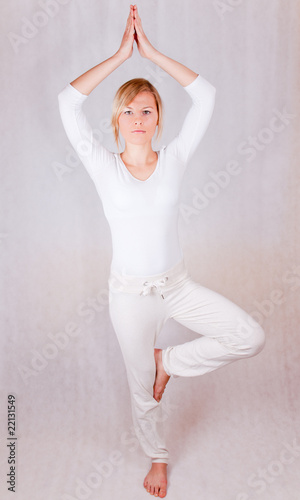 young woman relaxing (standing) - on white background