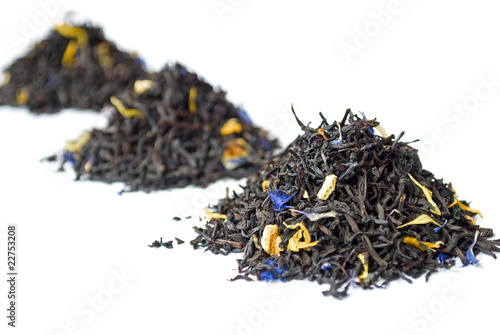 3 heaps of black Earl Grey tea isolated on white