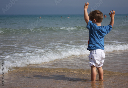 2-year-old child playing on the beach