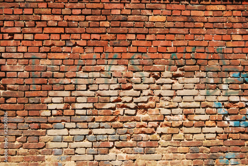 Old red brick wall with inscriptions