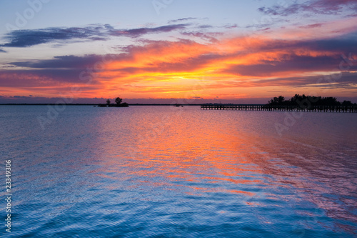 Dramatic sky before sunrise in golden colors on Indian river