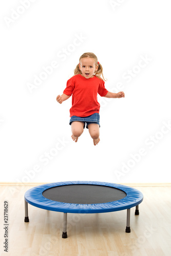Little girl jumping on trampoline
