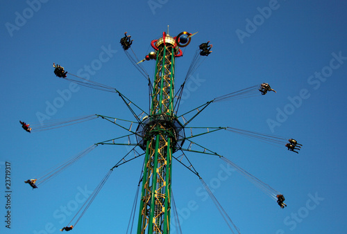 Rotating carousel on a background of the blue sky.