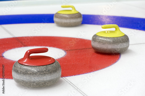 Group of curling rocks on ice