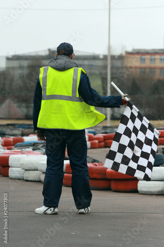 Worker with flag on go-cart racing
