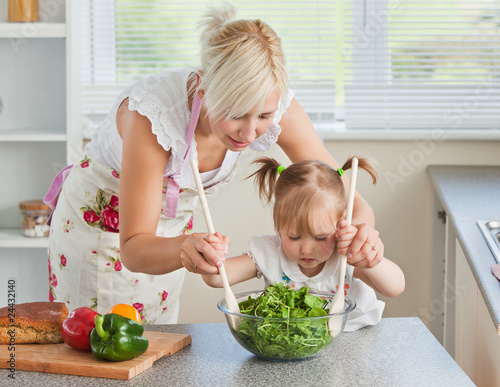 Blond mother and child cooking