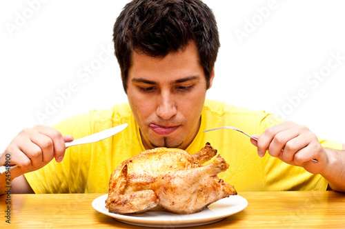 hungry young man waiting to eat freshly roasted whole chicken