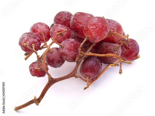 Small bunch of not so fresh grapes on white