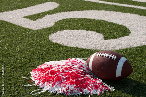 American Football and Pom Poms on Field