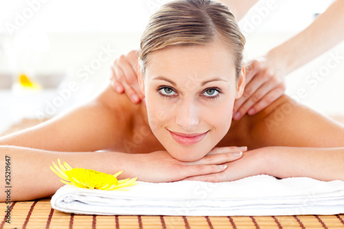 Portrait of a joyful woman lying on a massage table