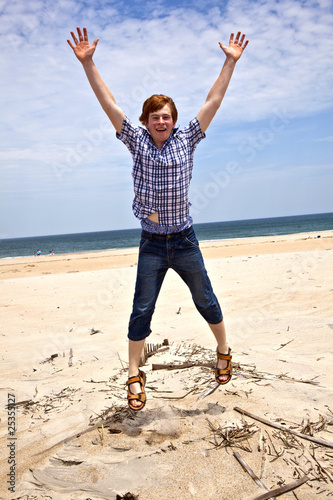 boy enjoys the beautiful beach and jumps