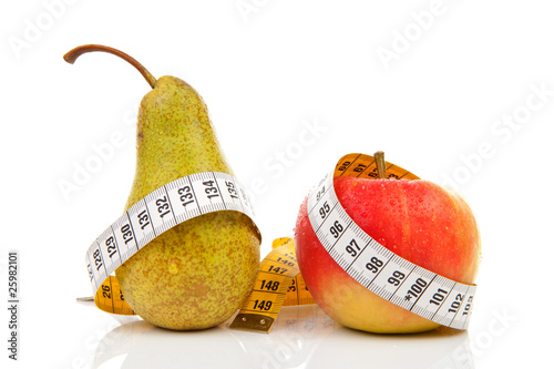 Pear and apple with measure tape over white background