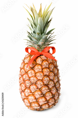 A ripe pineapple on a white background c red bow