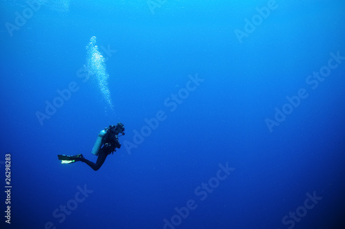 scuba diver in deep blue water