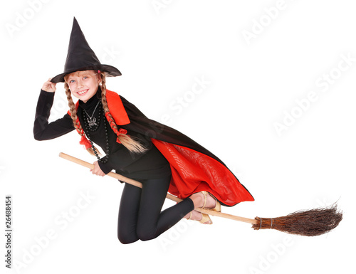 Child in costume Halloween witch fly on broom.