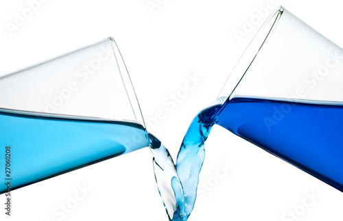 Two glasses spilling water or a similar blue liquid isolated on