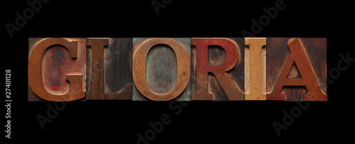 the word gloria in old wood type on black