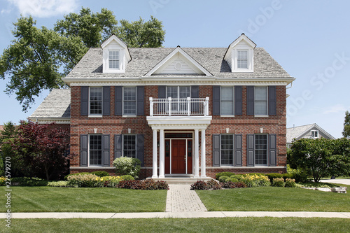 Brick home with front balcony