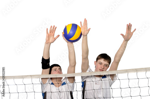 Volleyball players with the ball on a white